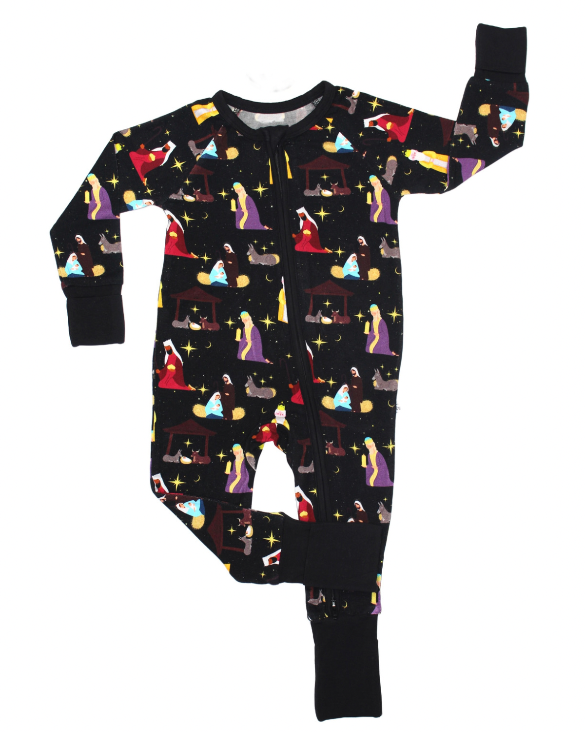 The Nativity Scene • Bamboo Zippy (Updated Fit) is a black long-sleeve baby romper with a colorful nativity print featuring Mary, Joseph, and Jesus. Made from soft bamboo fabric, it has black cuffs with one arm and one leg extended.