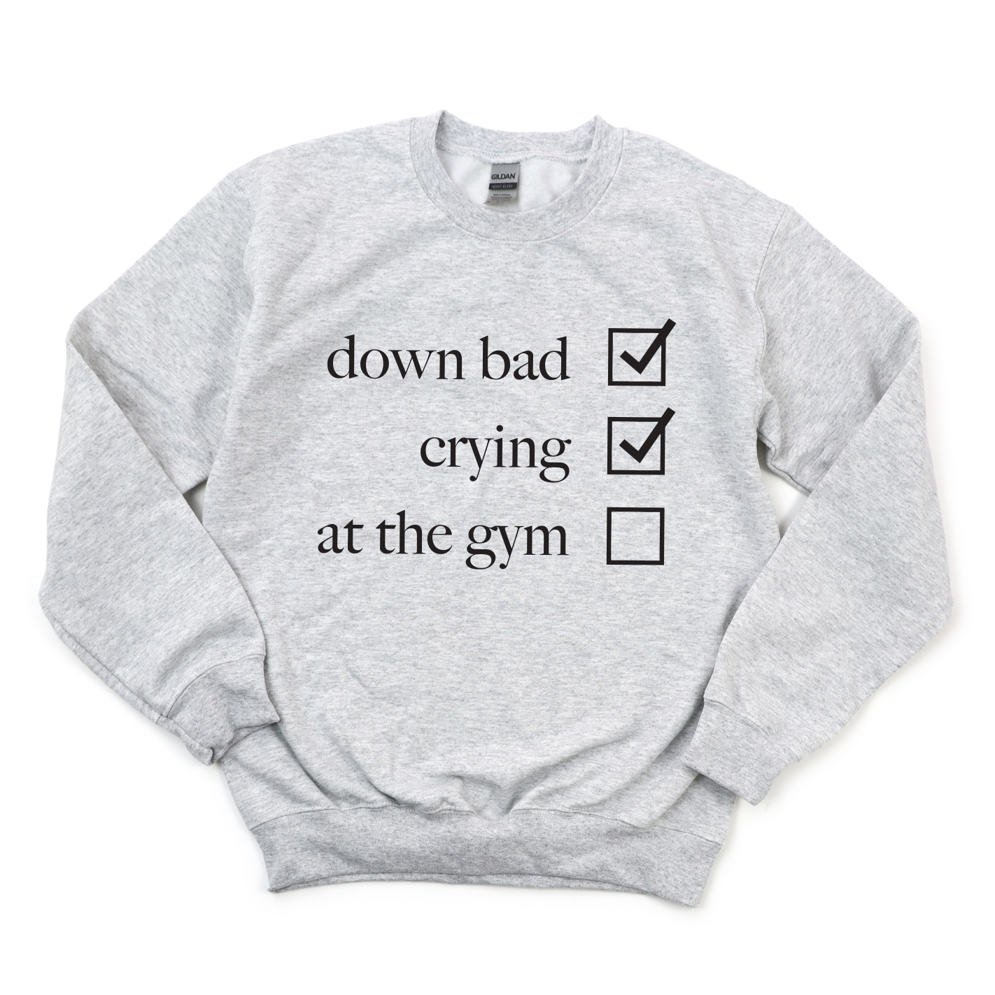 The Not at the Gym • Ash Pullover is a light gray cotton/polyester unisex sweatshirt with down bad and crying marked and at the gym unmarked in black text on the front.