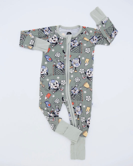 The Kickoff • Bamboo Zippy (Classic Fit) is a green onesie made from soft bamboo viscose, ideal for sensitive skin. It features cartoon dogs, soccer balls, trophies, goals, a front zipper, and light green cuffs on sleeves and legs.