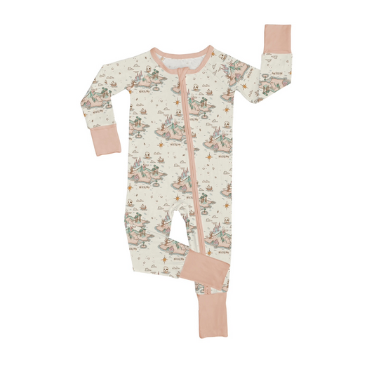 The Never Neverland • Bamboo Zippy (Updated Fit) is an infant or toddler zip-up onesie featuring light pink cuffs, collar, and feet, with a whimsical pattern of trees, animals, and houses on soft off-white bamboo fabric.