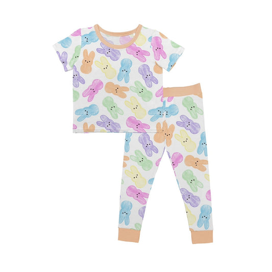 The Hoppy Dreams • 2 Piece Bamboo Set (Updated Fit) features a soft white short-sleeve top and pants with cute bunny faces, plus light tan collar, cuffs, and waistband. Made from cozy bamboo viscose for extra comfort.