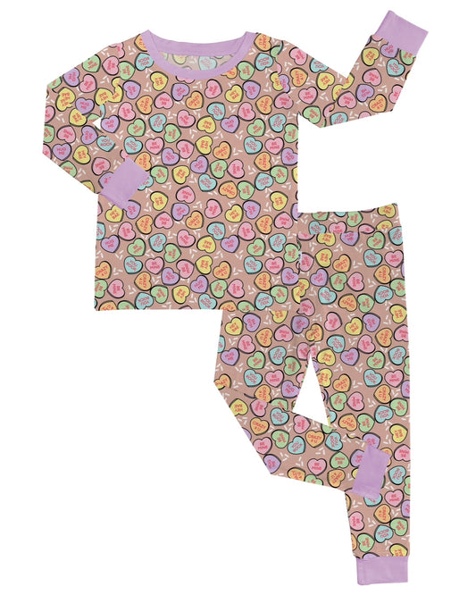 The Be Mine • 2 Piece Bamboo Set (Updated Fit) features long sleeves and pants with a colorful heart pattern, lavender cuffs and collar, and is crafted from bamboo viscose—ideal for sensitive skin.