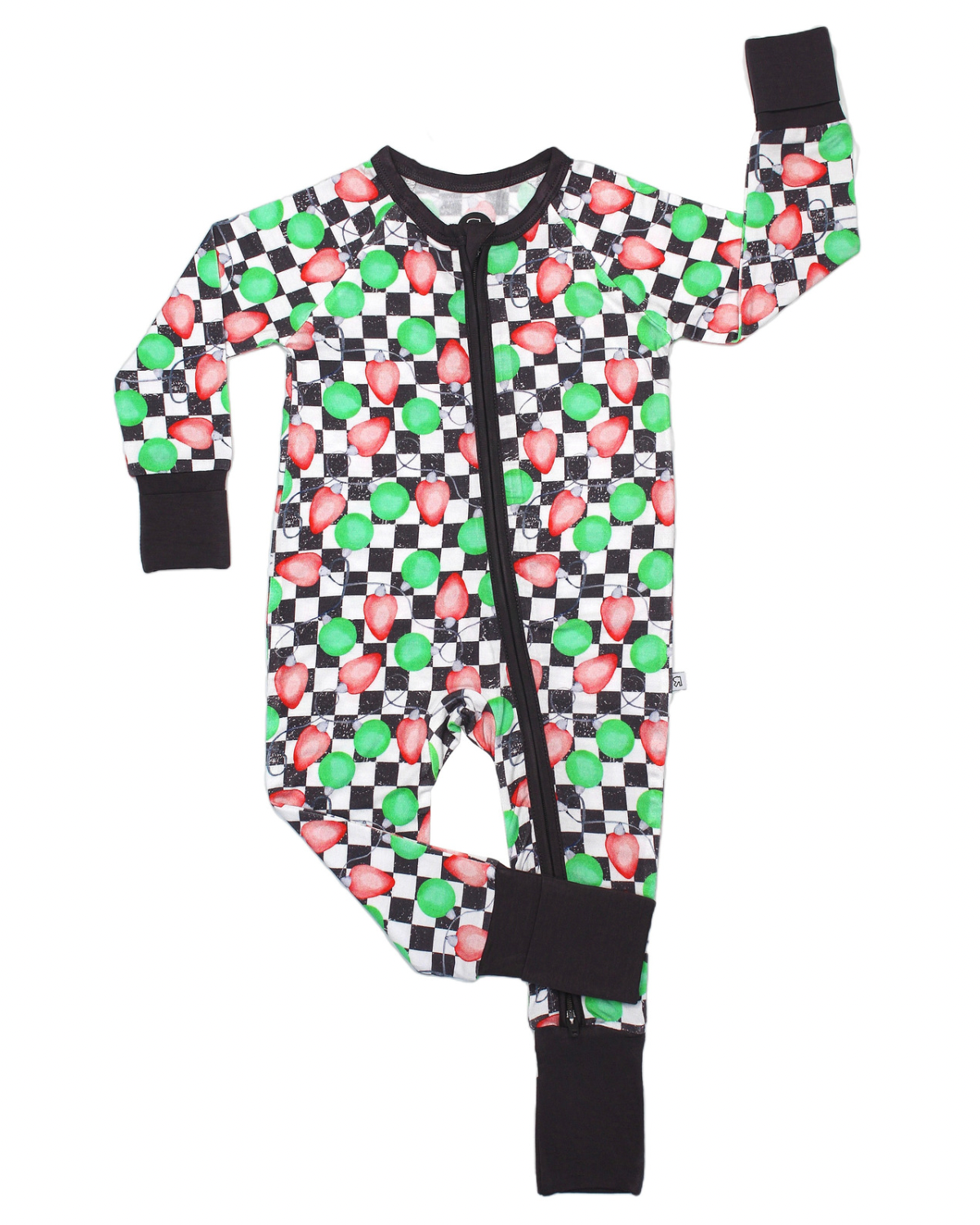 The Checkered Lights • Bamboo Zippy (Updated Fit) is a children’s one-piece pajama featuring black cuffs, a zipper, and a green and red mushroom checkered print inspired by video games. Crafted from soft bamboo fabric, with one arm and leg raised.