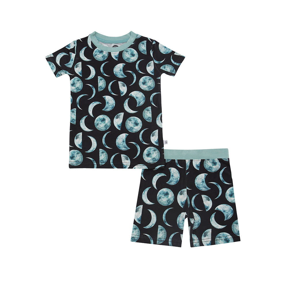 The Moon Child • Short Sleeve Set (Classic Fit) features a blue and white moon phase pattern on black with light blue trim, made from soft bamboo viscose—ideal for sensitive skin.