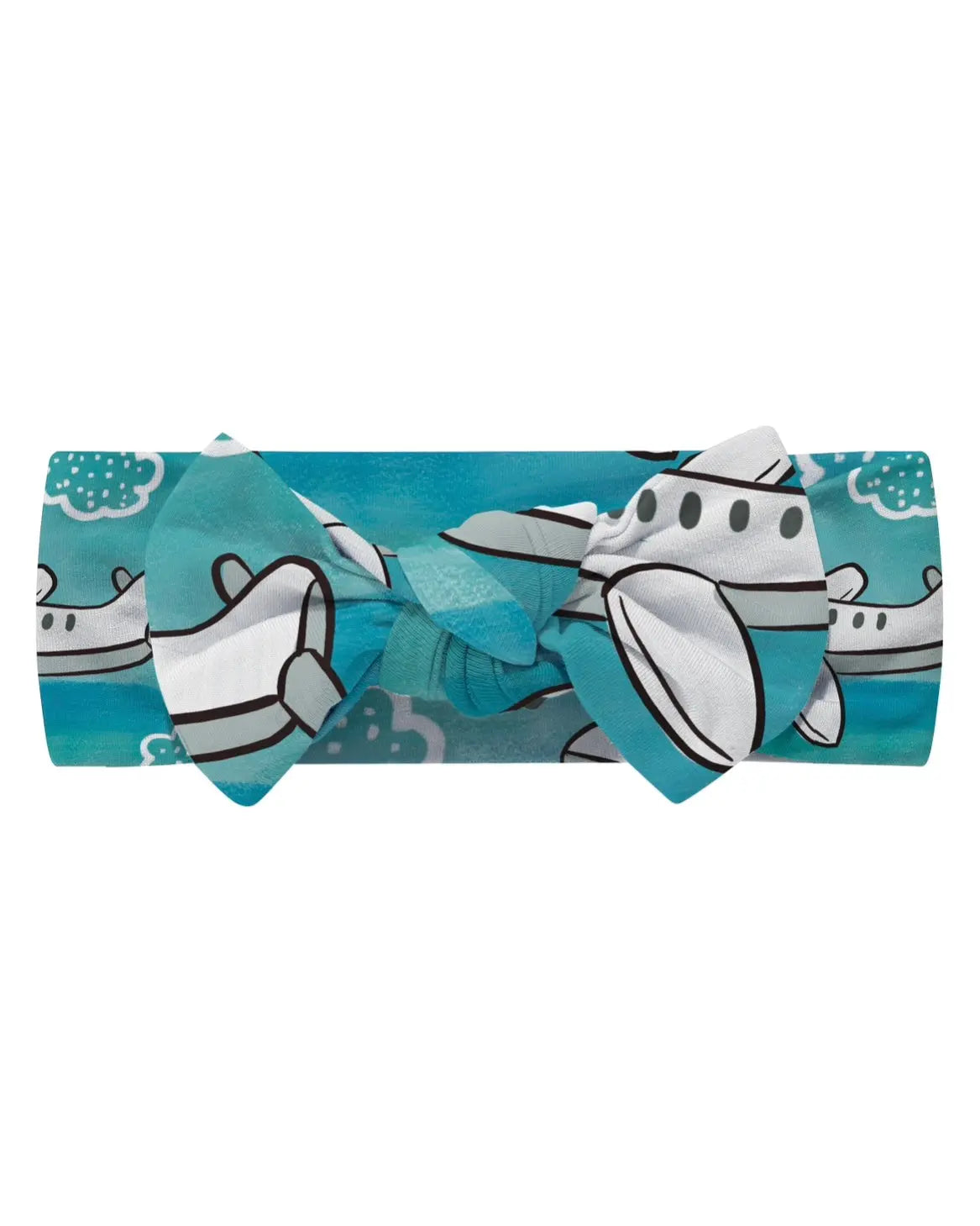 The Up Up & Away • Bow Headwrap is a blue bamboo headband with a bow, decorated with white, gray, and black cartoon airplanes and clouds.