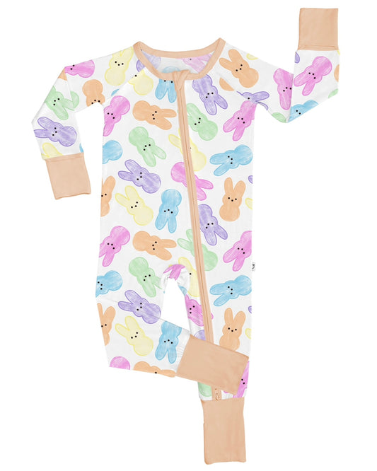 The Hoppy Dreams • Bamboo Zippy (Updated Fit) is a soft bamboo viscose baby onesie featuring pastel bunny faces in pink, yellow, green, blue, and purple, peach cuffs and neckline, gentle on sensitive skin with a diagonal front zipper.