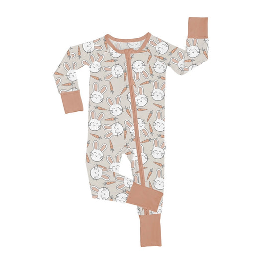 The Snuggle Bunny • Bamboo Zippy (Updated Fit) is a beige bamboo onesie with white cartoon bunnies, carrots, peach trim, a comfy grow-with-me design, and features one sleeve and one leg raised.