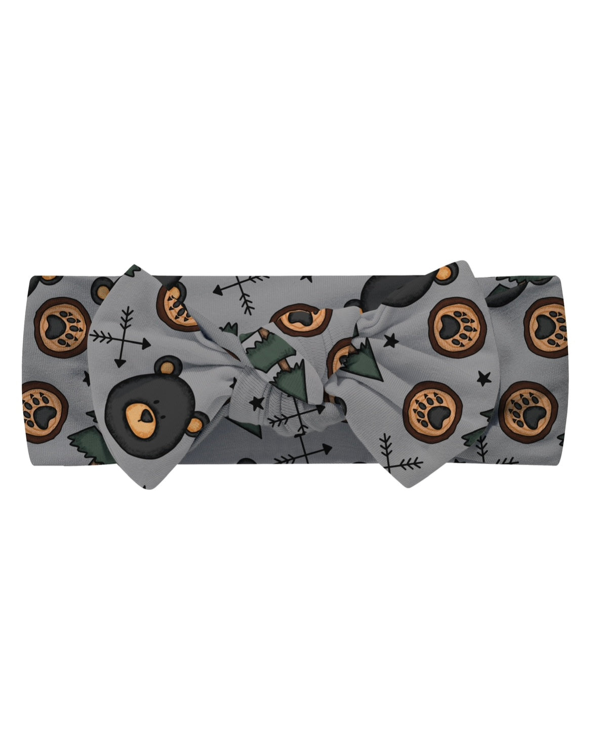 The Beary Cozy • Bow Headwrap is a gray bamboo headband with a bow, decorated with black, green, and brown bear paw prints, trees, arrows, and stars. Its stretchy fabric offers both comfort and style.