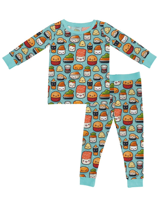 The Sushi Rolls • 2 Piece Bamboo Set (Updated Fit) features children’s pajamas with a light blue background and cute cartoon sushi print. Made from super stretchy bamboo, the set includes a long-sleeve top and pants for comfy sleep.