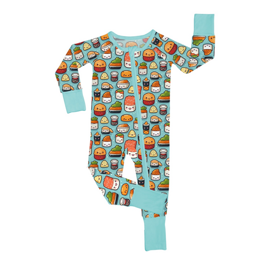 The Sushi Rolls • Bamboo Zippy (Updated Fit) is a colorful baby onesie with light blue cuffs and collar, featuring playful cartoon sushi, burgers, and fries on a dark background. One sleeve and leg are raised.