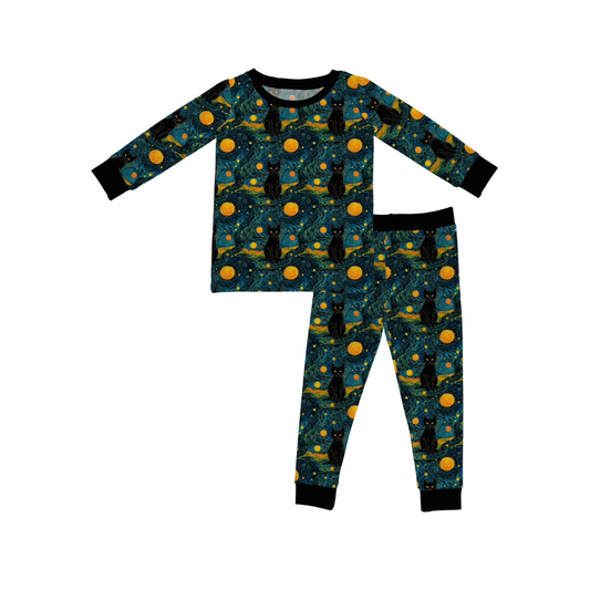 The Starry Cats • 2 Piece Bamboo Set (Updated Fit) includes a long-sleeve top and pants made from super stretchy fabric, featuring Van Gogh Starry Night-inspired prints with black cat silhouettes and yellow moons and stars.