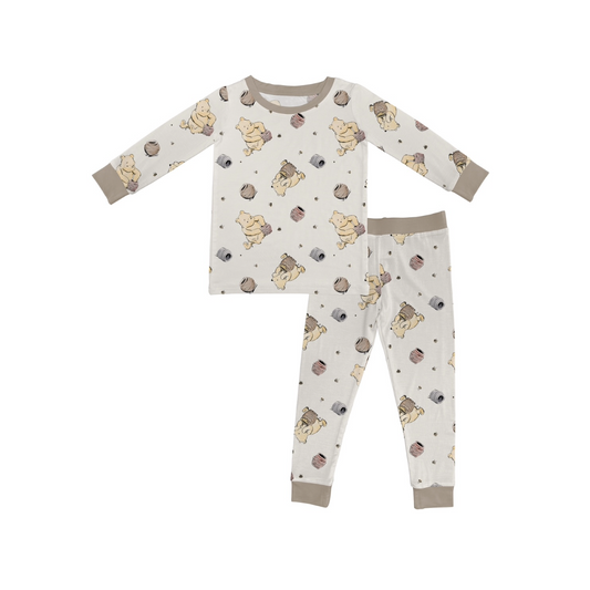 The Classic Pooh • 2 Piece Bamboo Set (Updated Fit) is a childrens pajama set with long sleeves and pants, featuring an all-over print on soft, stretchy bamboo viscose for cozy comfort.