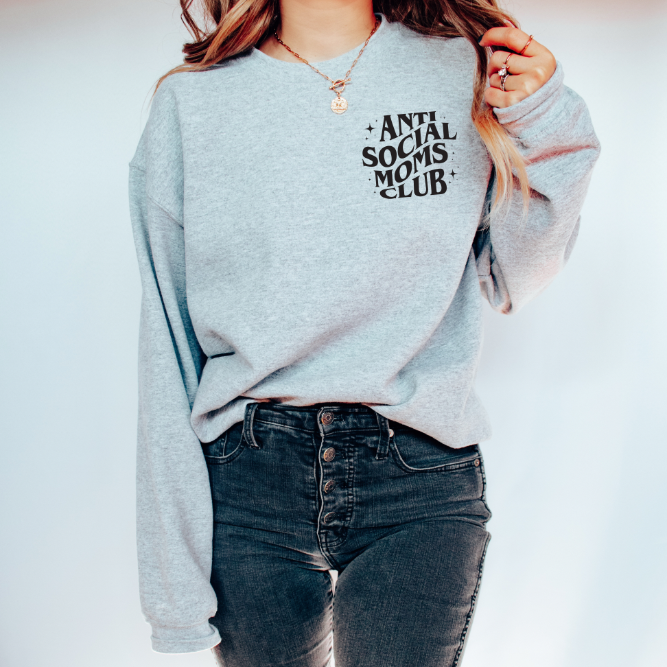 A person is wearing the Anti-Social Moms • Heather Gray Crew and high-waisted black jeans while standing against a plain white background.
