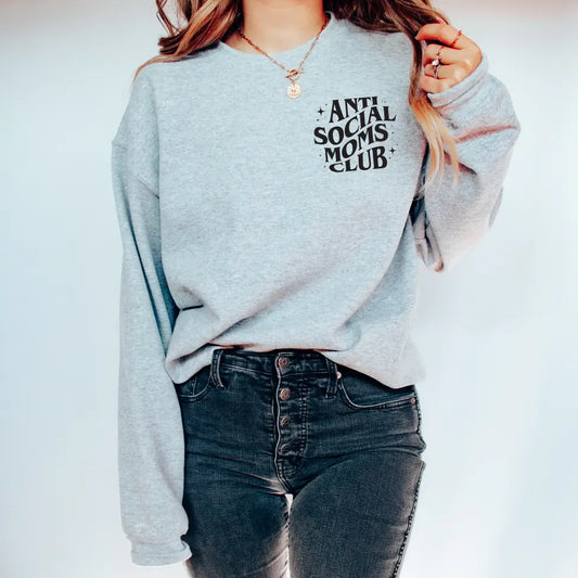 A person is wearing the Anti-Social Moms • Heather Gray Crew and high-waisted black jeans while standing against a plain white background.