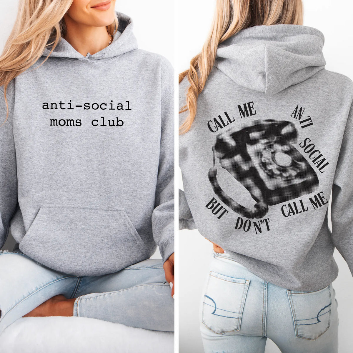A woman wears the Dont Call Me • Gray Hoodie, a cozy unisex fleece from the Heavy Blend collection. The front reads “anti-social moms club” and the back shows a vintage rotary phone with “Call me anti social, but don’t call me.”.