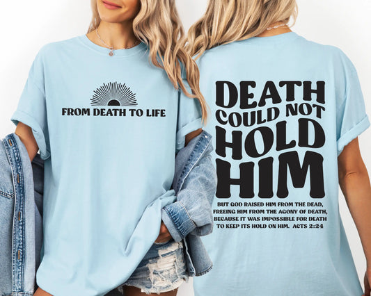 Light blue t-shirt with text 'From Death to Life' on front and 'Death could not hold him' on back, worn by a person.