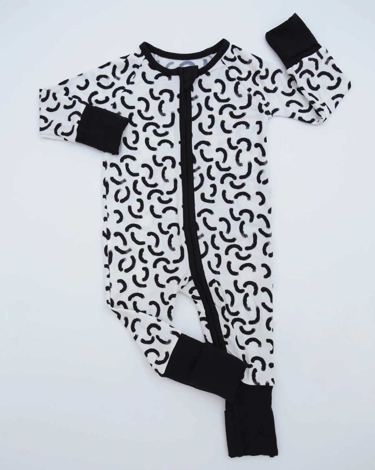 The Monochrome • Bamboo Zippy (Classic Fit) is a cozy black and white baby onesie with abstract curved shapes, solid black cuffs, collar, and zipper on a white background—crafted from soft bamboo viscose for all-day comfort.
