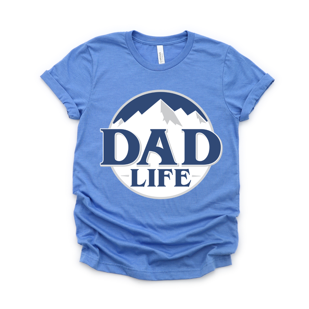The Latte Dad • Athletic Blue Tee is a unisex Tultex shirt in blue, featuring a circular mountain graphic and bold DAD LIFE text on the front. Made from premium combed cotton for comfort and style.