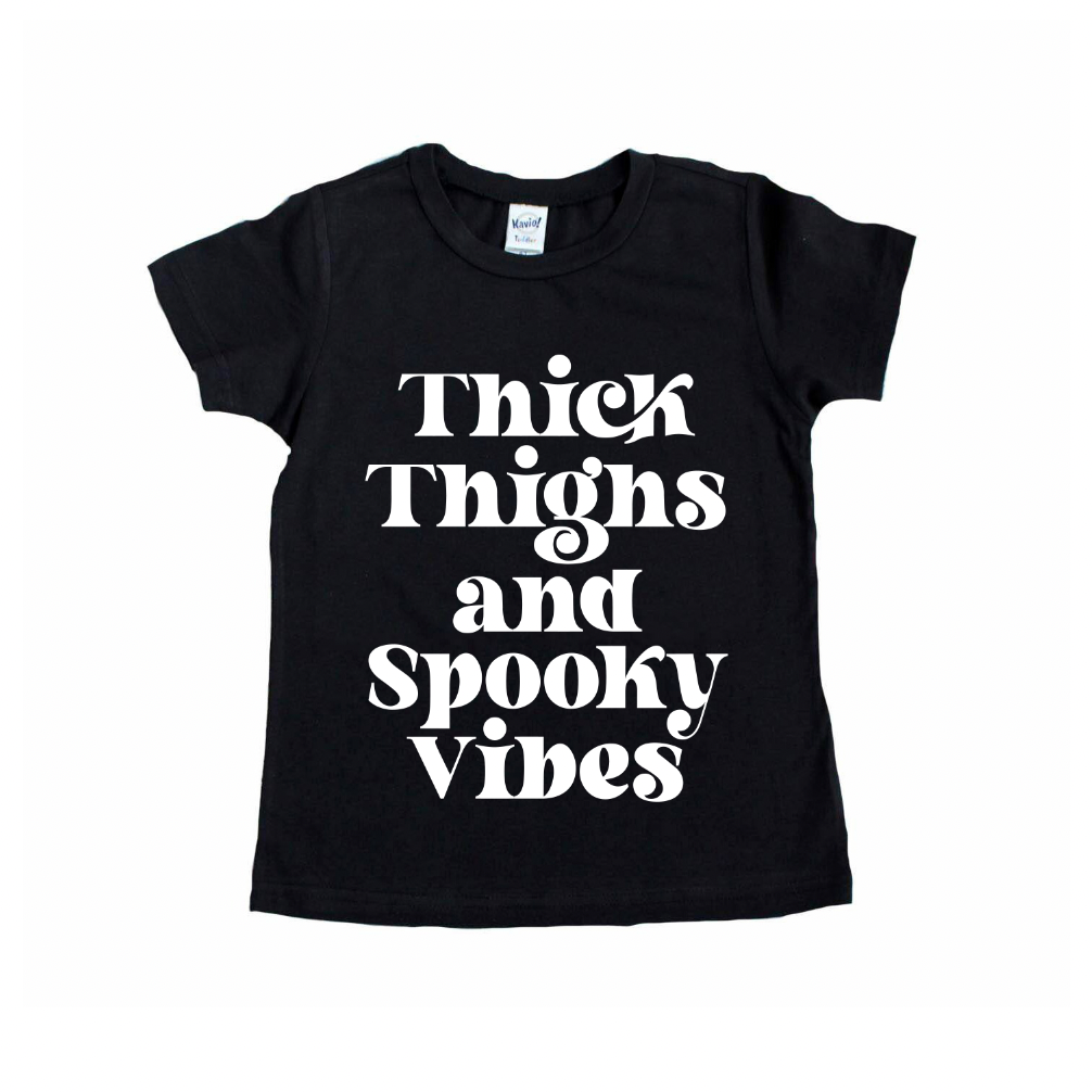 The Thick Thighs • Kids Tee is a black shirt with bold white text, “Thick Thighs and Spooky Vibes,” perfect for fun Mommy and Me looks. Displayed on a plain white background.