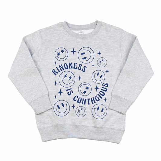 The Kindness • Kids Pullover is a light gray sweatshirt with blue smiley faces, stars, and Kindness is Contagious in a playful font. Unisex sizing offers a comfy oversized fit—perfect for kids’ clothing collections.