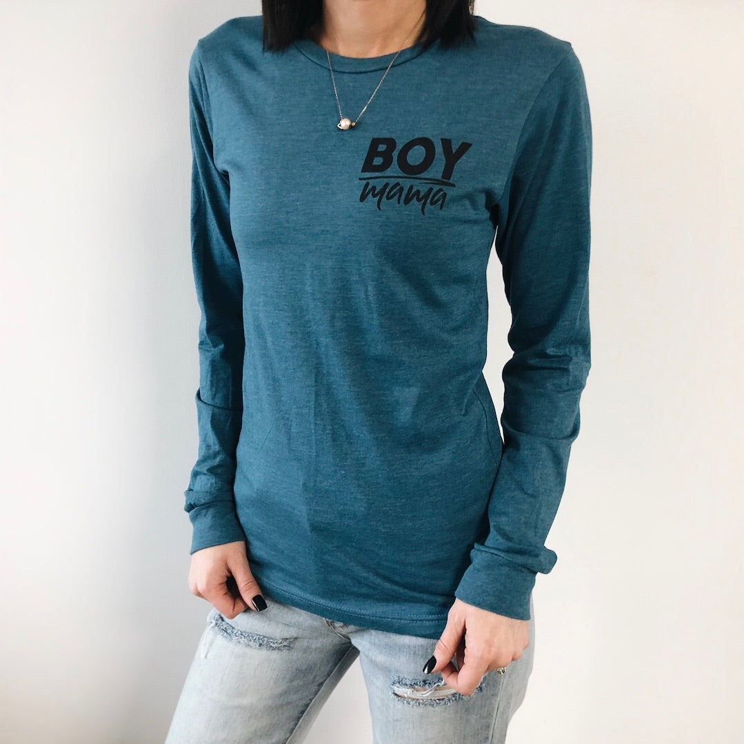 A person models the Boy Mama • Heather Teal Long Sleeve, featuring Boy Mama in black on the chest, paired with light ripped jeans and a necklace, set against a white background.