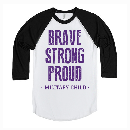 The Military Kid Raglan is a white and black shirt with bold purple BRAVE STRONG PROUD text above MILITARY CHILD, ideal for proud Military Kids or supporters of the National Military Family Association.